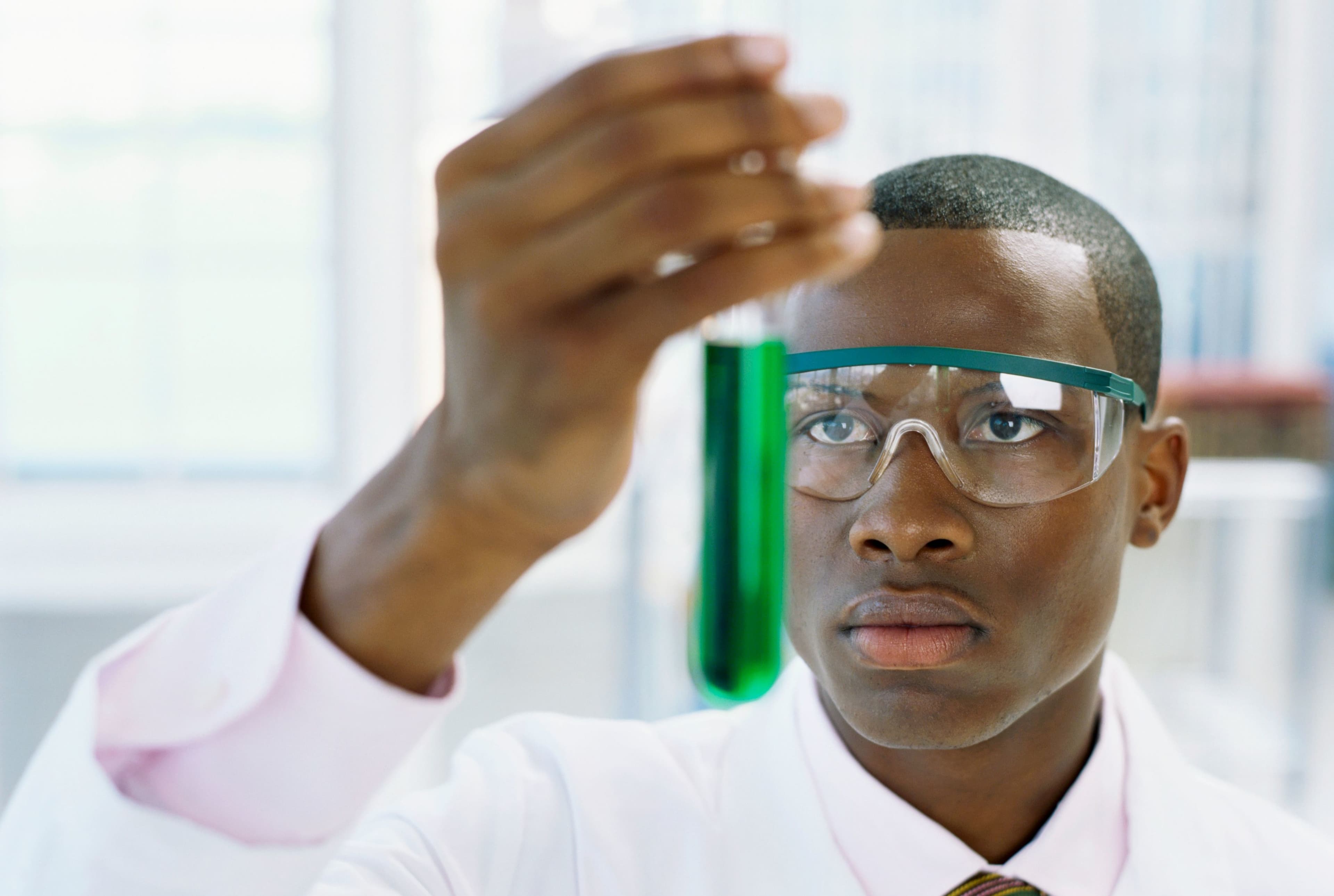 Scientist examining test tube