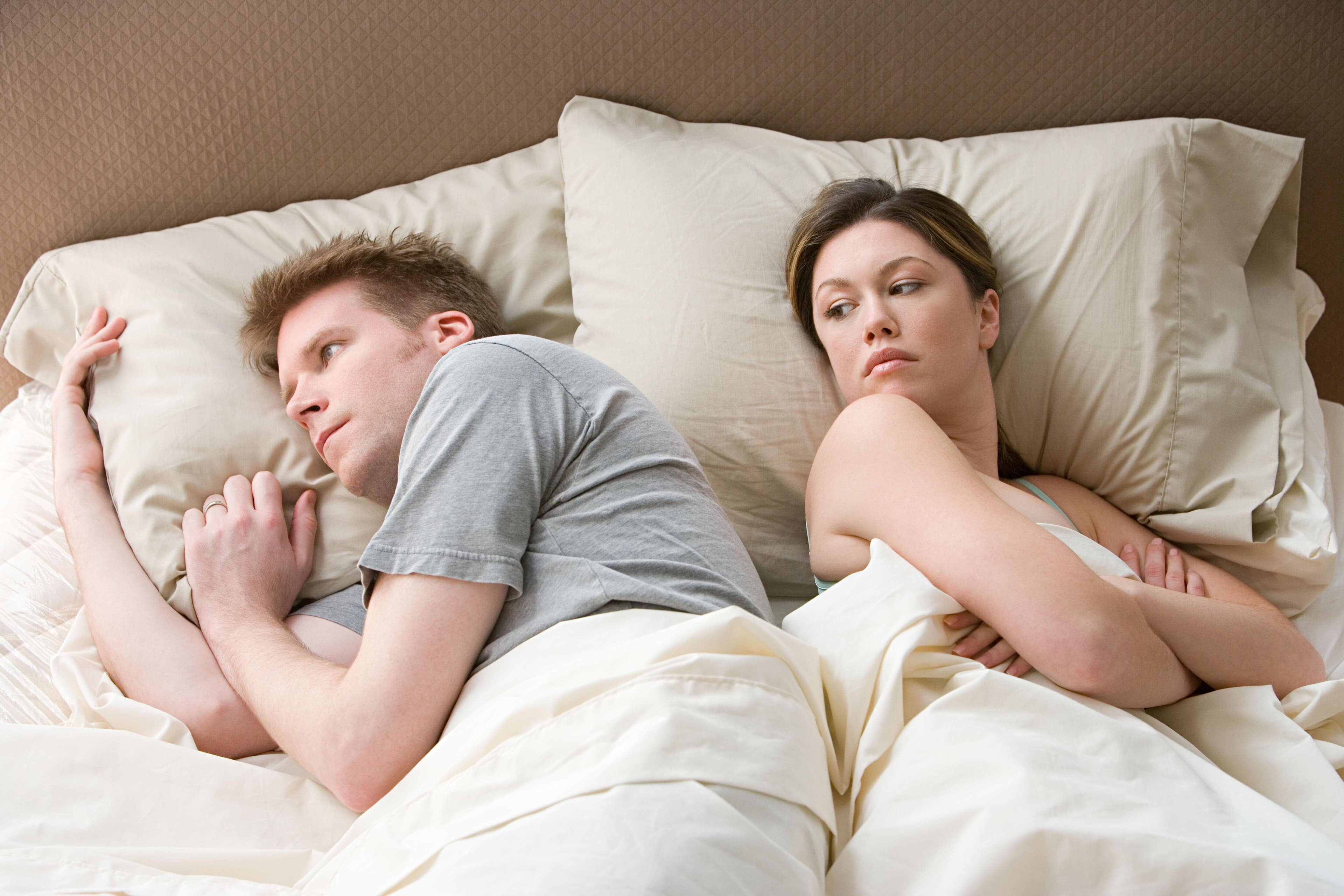 Couple arguing in bed